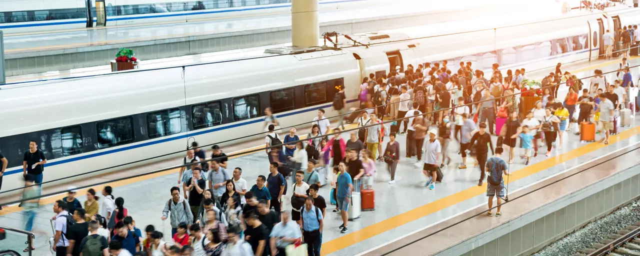 Crowd Of Passengers Waiting On Station Platform.
