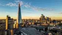 Skyline view of London buildings during sunrise, featuring the shard.