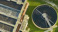 Aerial view of modern water cleaning facility at urban wastewater treatment plant. Purification process of removing undesirable chemicals, suspended solids and gases from contaminated liquid.